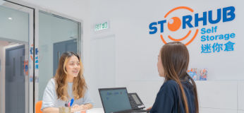 Storage specialist and customers in StorHub reception area